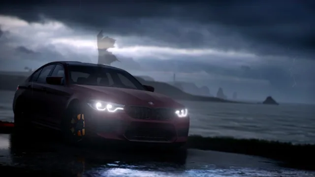 Red BMW M5 F90 beside a stormy coast at night
