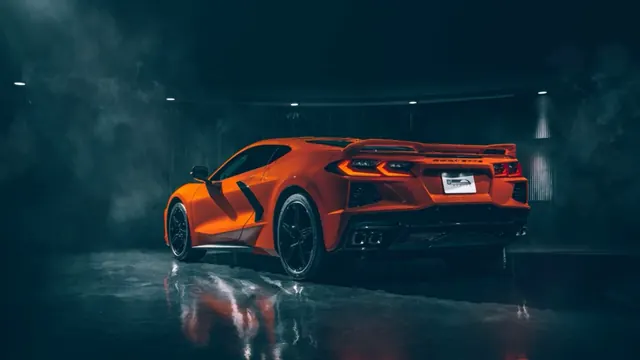 Orange Chevrolet Corvette Stingray C8 reflected on a garage floor
