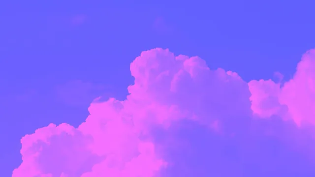 Soft pink and purple clouds illuminated by the fading light of sunset