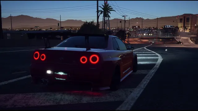 Nissan Skyline GT-R R34 framed by evening lights on a city street