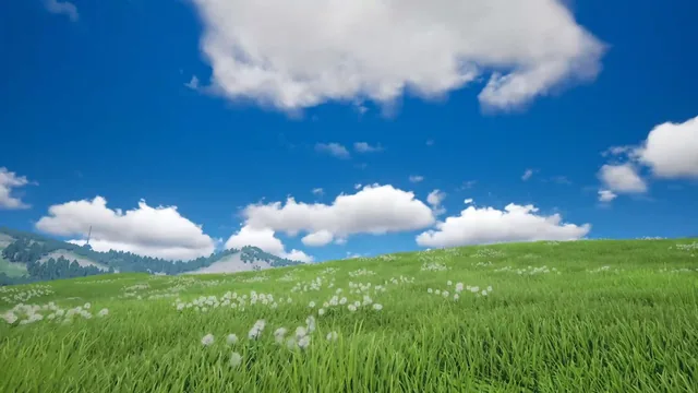 Peaceful grassland extending beneath an open blue sky