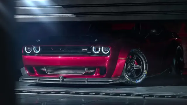 Red Dodge Challenger Hellcat under cold neon in a dark garage