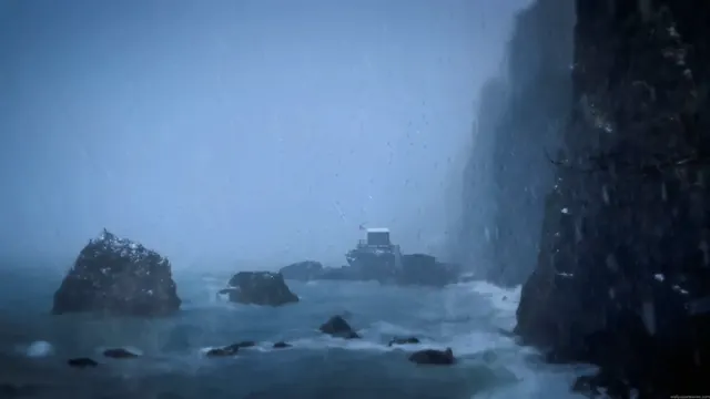 Rain falling across a dark and stormy coastal landscape