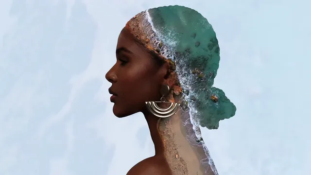 Woman's profile silhouette blended with ocean waves in a double-exposure portrait